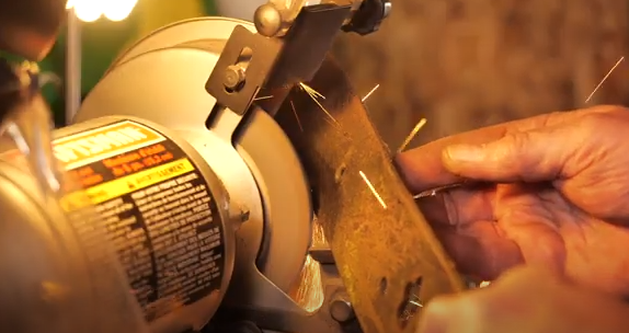 Sharpening the lawn mower blade.