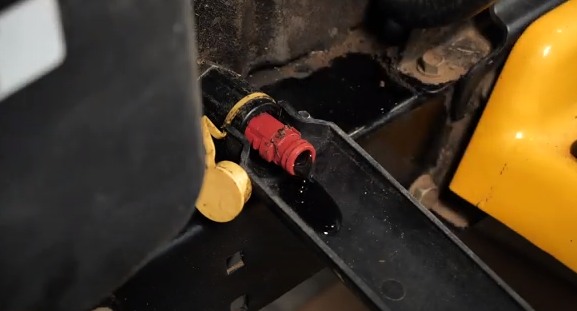 Draining the old oil from the lawn tractor.