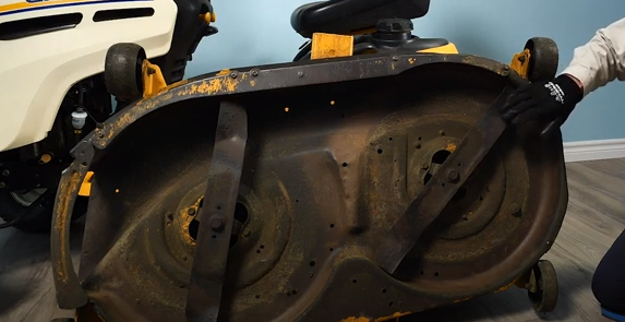 The underside of the lawn tractor mower deck.