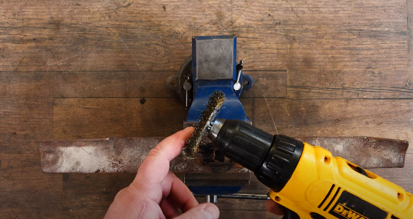 Removing loose rust and debris with wire wheel