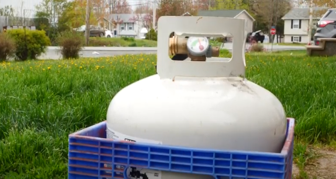 Place the propane tank in a milk crate to secure it