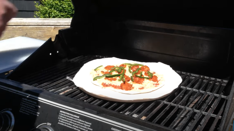 Pizza cooking on the grill